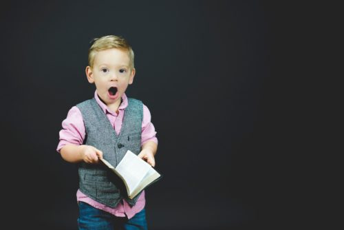 surprised child with book