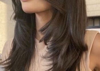 Straight bangs styled with round brush for soft curves